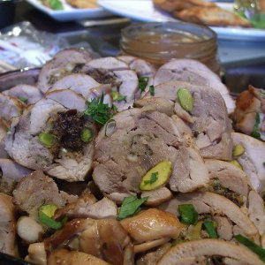 Roast pork stuffed with ham, pistachios and oranges